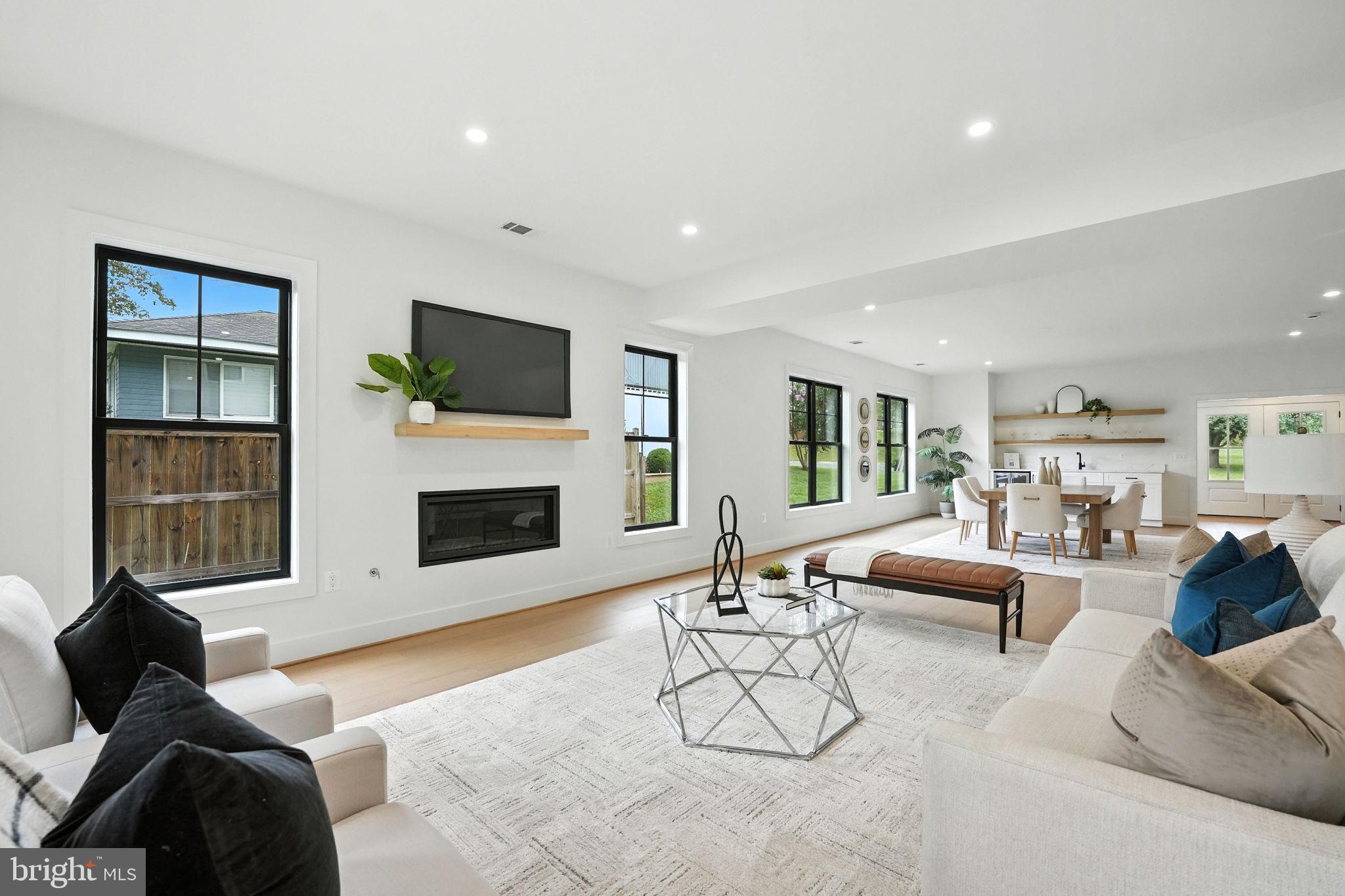 8118 Drayton Lane Springfield, VA 22151 - Photo 17 of 71 a living room with furniture a fireplace and a flat screen tv