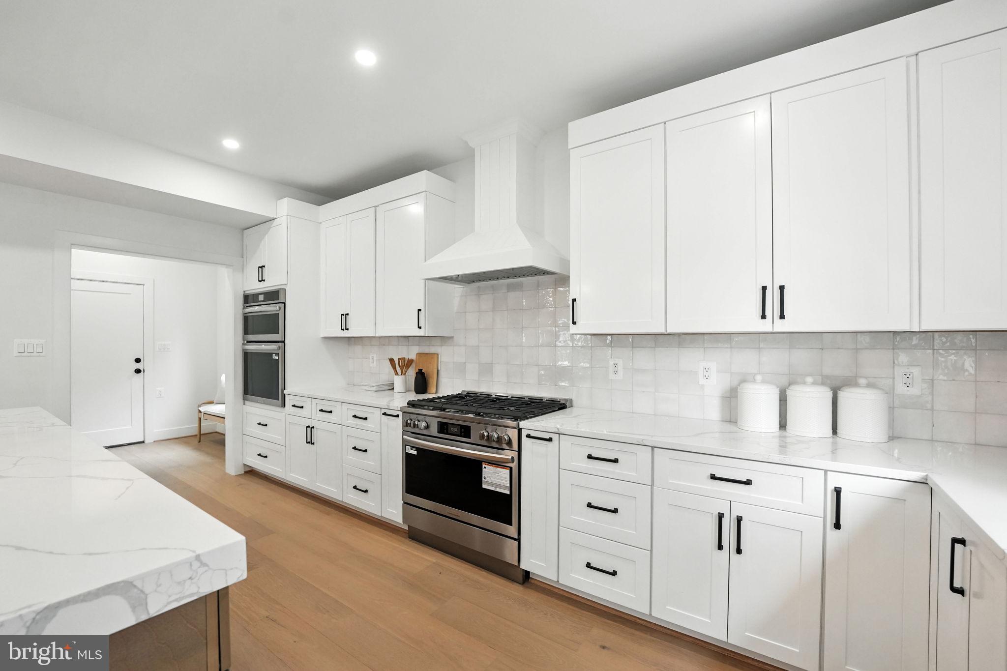 8118 Drayton Lane Springfield, VA 22151 - Photo 22 of 71 a kitchen with granite countertop white cabinets and stainless steel appliances