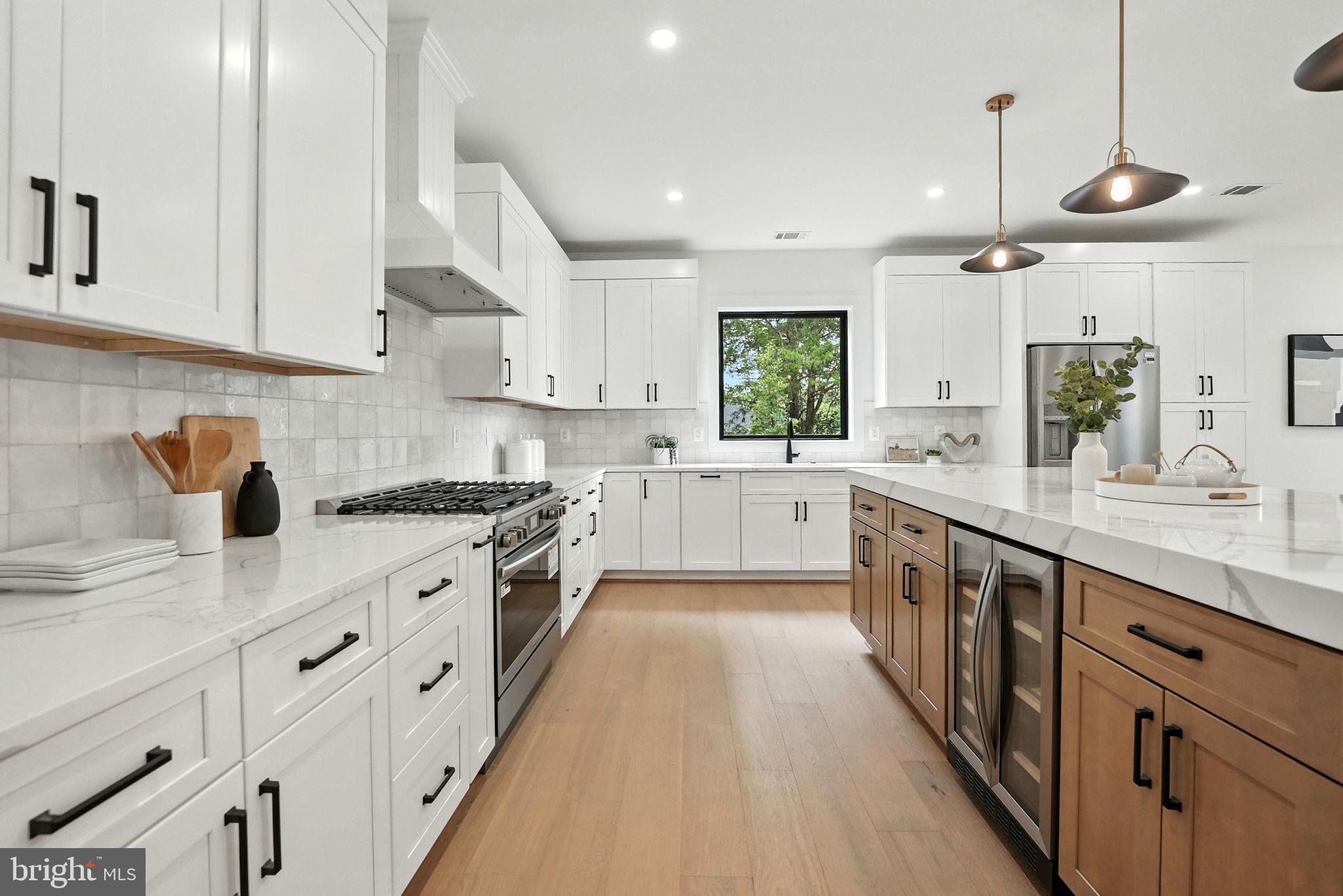 8118 Drayton Lane Springfield, VA 22151 - Photo 25 of 71 a large kitchen with stainless steel appliances sink a stove and white cabinets