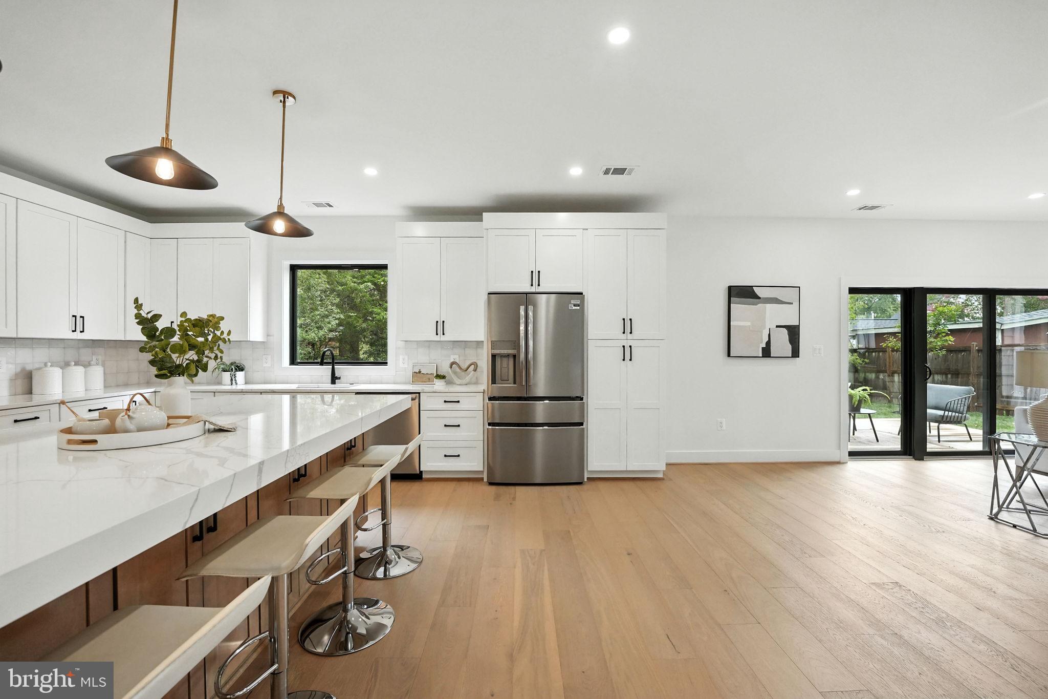 8118 Drayton Lane Springfield, VA 22151 - Photo 27 of 71 a kitchen with stainless steel appliances granite countertop a refrigerator a sink dishwasher a stove and a refrigerator with wooden floor