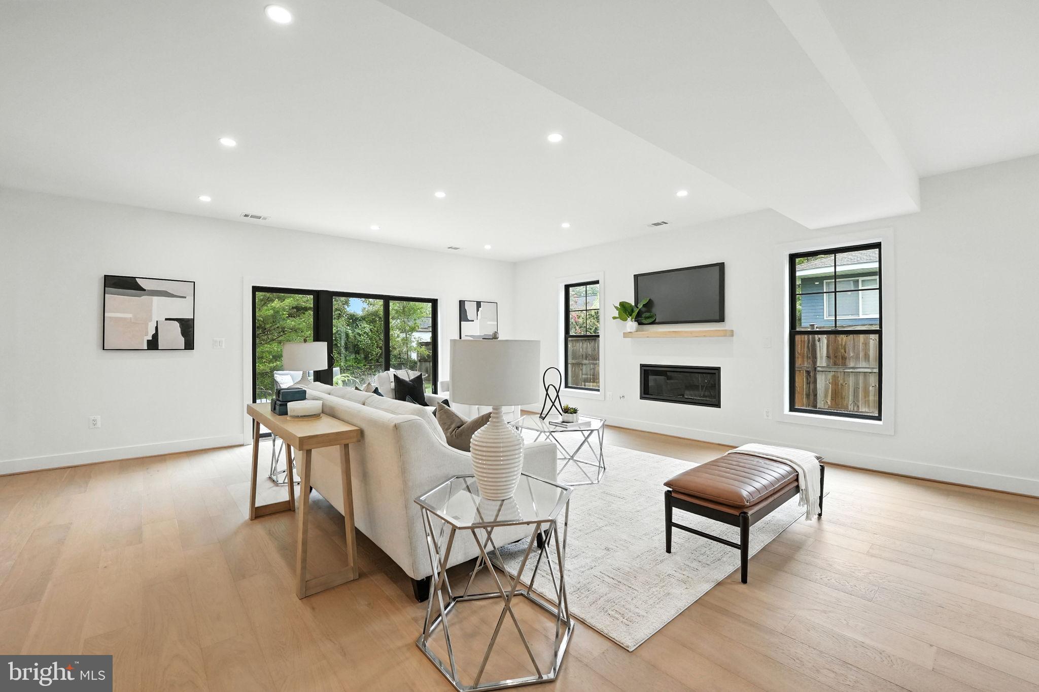 8118 Drayton Lane Springfield, VA 22151 - Photo 32 of 71 a living room with furniture a fireplace and a table
