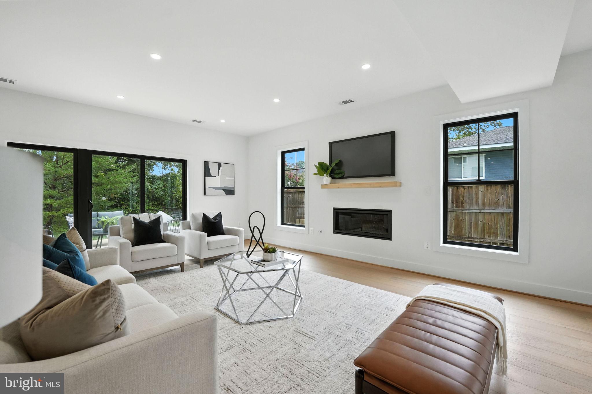 8118 Drayton Lane Springfield, VA 22151 - Photo 33 of 71 a living room with furniture a flat screen tv and a fireplace