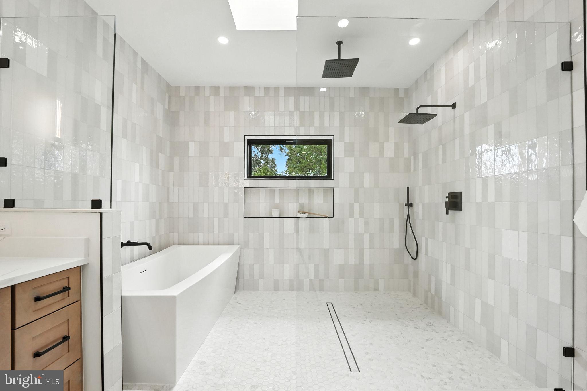 8118 Drayton Lane Springfield, VA 22151 - Photo 45 of 71 a bathroom with a bathtub a shower a sink and a shower