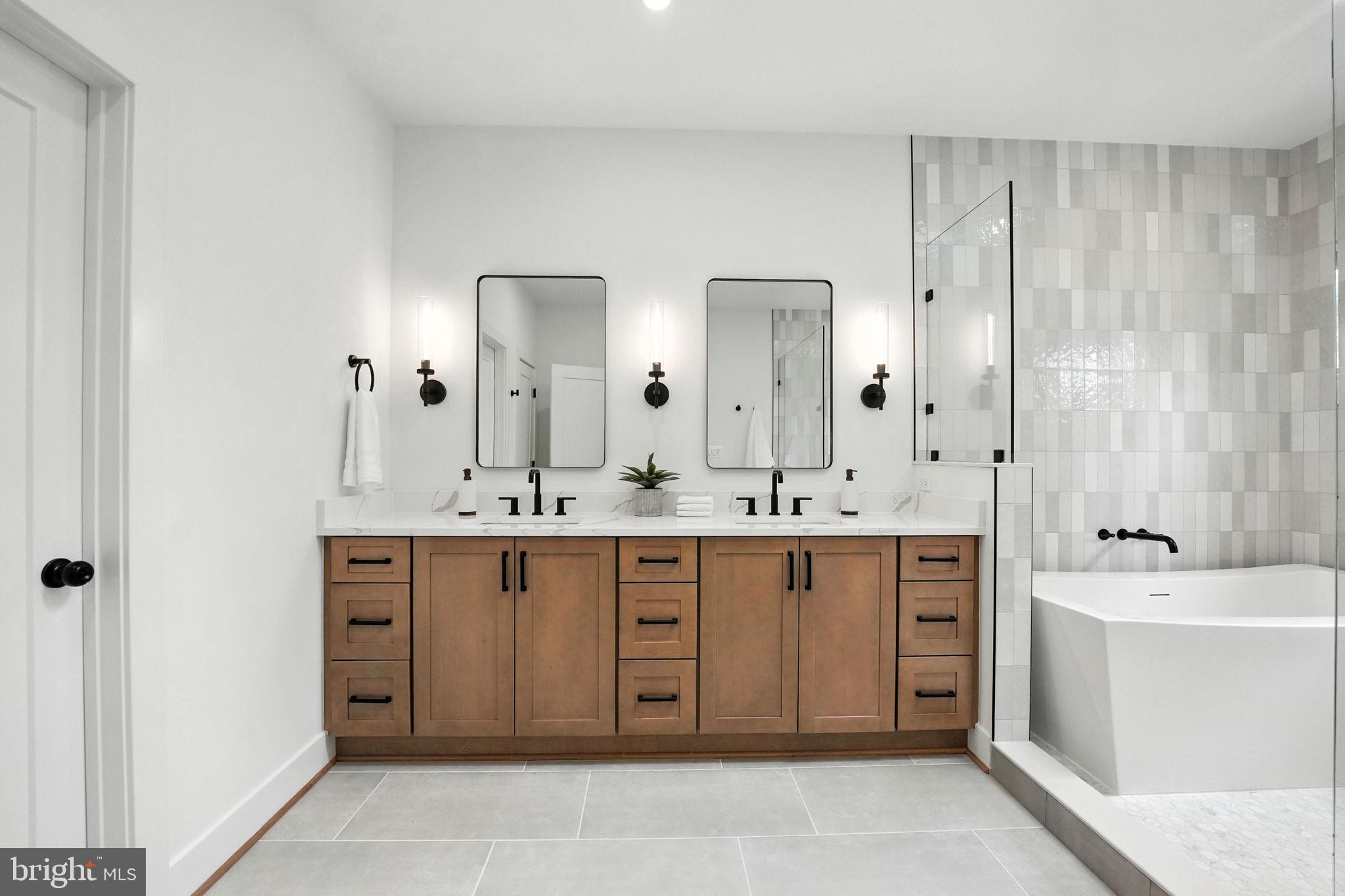 8118 Drayton Lane Springfield, VA 22151 - Photo 46 of 71 a spacious bathroom with a double vanity sink a mirror and a bathtub
