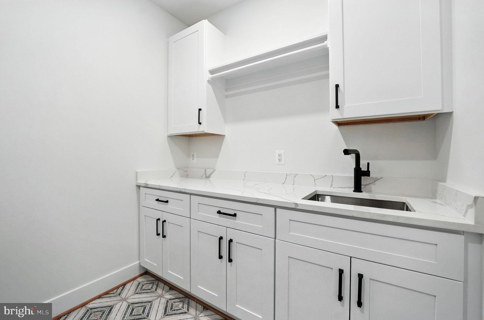 8118 Drayton Lane Springfield, VA 22151 - Photo 47 of 71 a kitchen with white cabinets and a sink