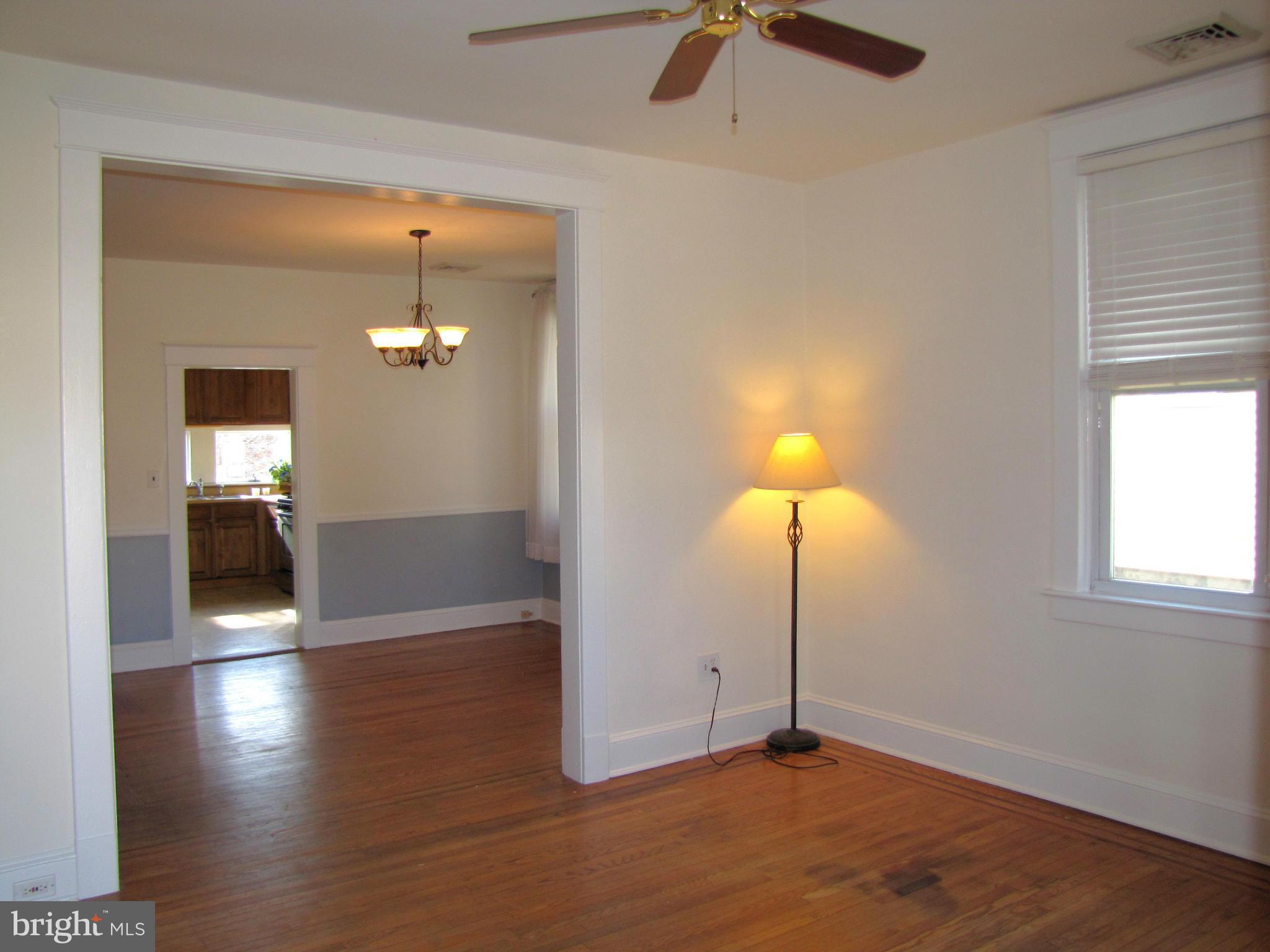 41 Edmondson Ridge Road Baltimore, MD 21228 - Photo 2 of 30 wooden floor in an empty room with a window
