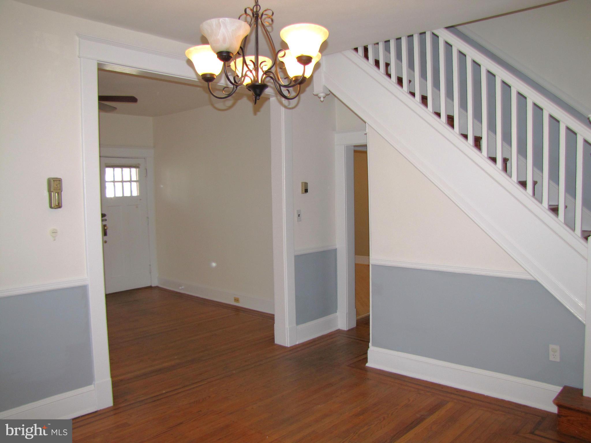 41 Edmondson Ridge Road Baltimore, MD 21228 - Photo 7 of 30 a view of a hallway with wooden floor and staircase