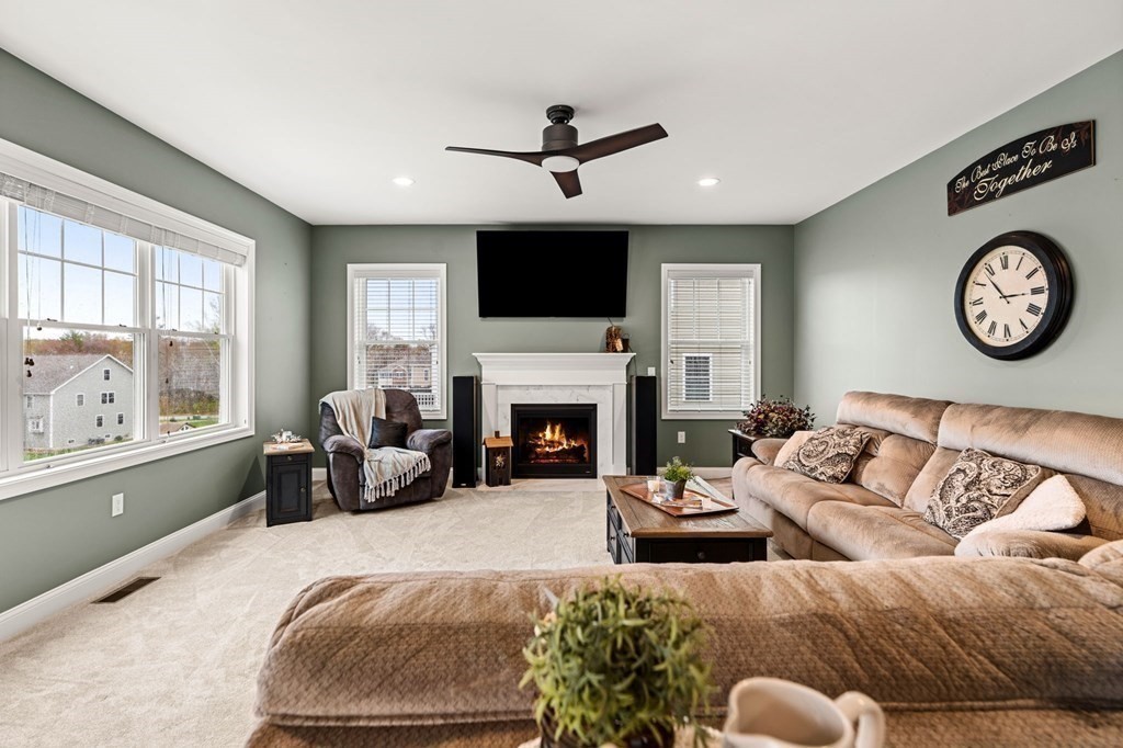 10 Schoolhouse Road, Unit 10 Londonderry, NH 03053 - Photo 13 of 38 a living room with furniture fireplace and window