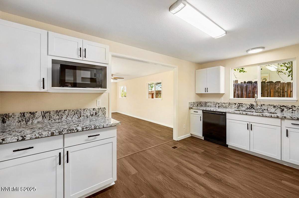 3670 Meeks Way Reno, NV 89503 - Photo 6 of 21 a kitchen with stainless steel appliances granite countertop a stove a sink and a microwave