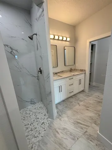 a spacious bathroom with a sink a toilet and shower