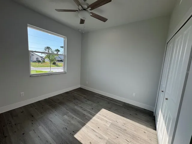 wooden floor in an empty room with a window