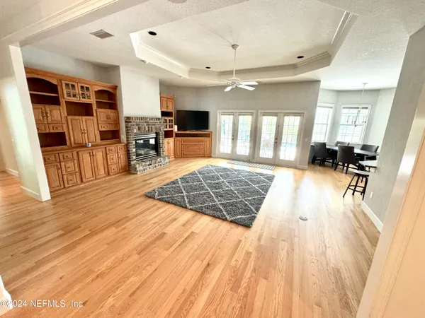 a large room with wooden floor and furniture