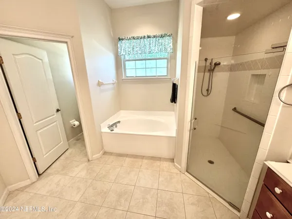 a bathroom with a tub shower and a sink
