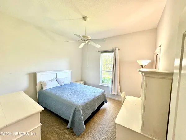 a bedroom with a bed and a table