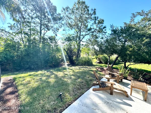 a backyard of a house with yard and outdoor seating