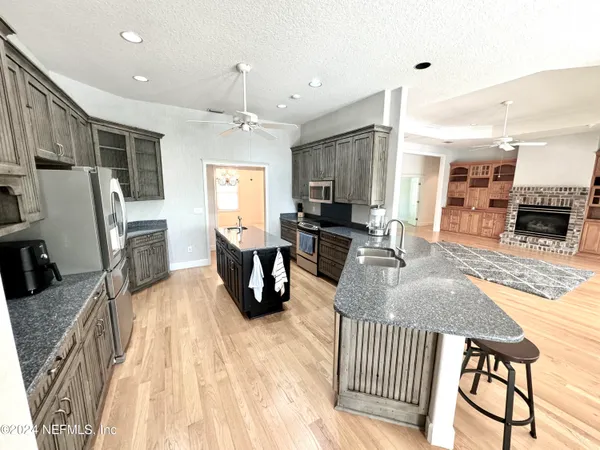a living room with fireplace furniture and a flat screen tv