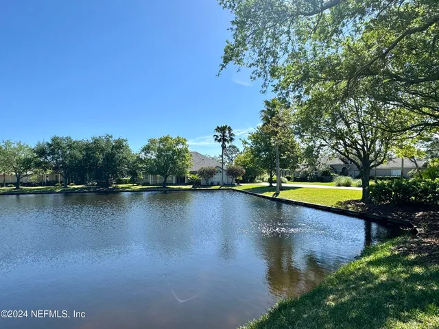 a view of a lake with houses in the back