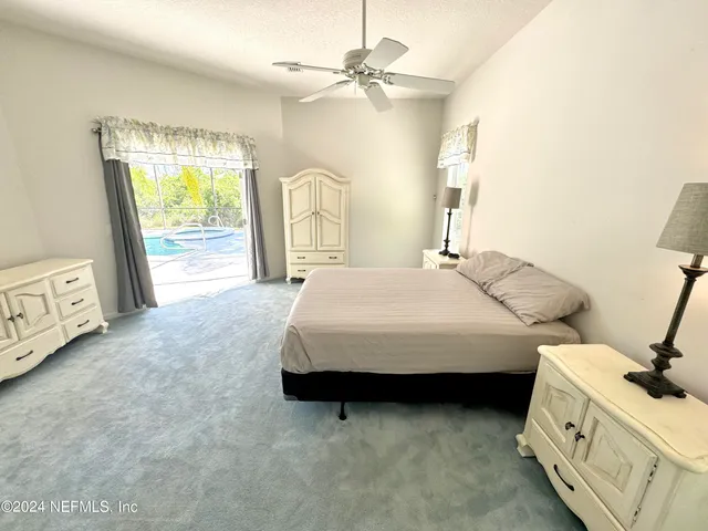 a spacious bedroom with a bed and a table
