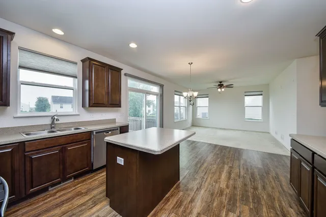 a kitchen with sink a microwave and cabinets