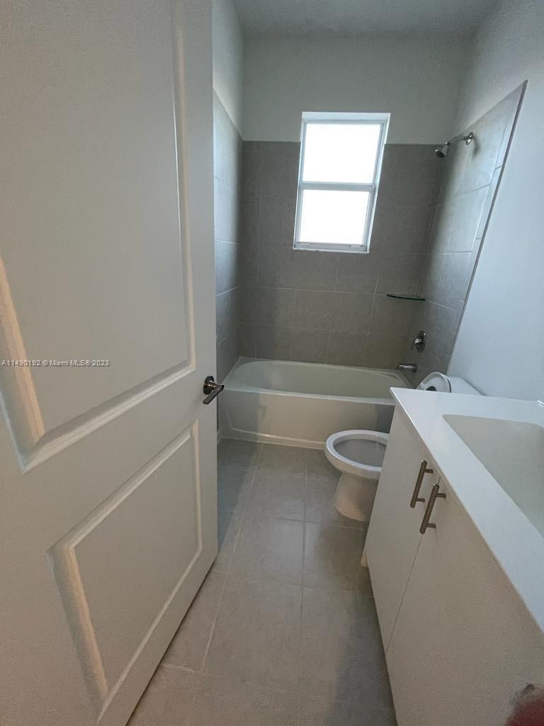 29111 Southwest 162th Court Homestead, FL 33033 - Photo 14 of 15 a bathroom with a granite countertop sink toilet and shower
