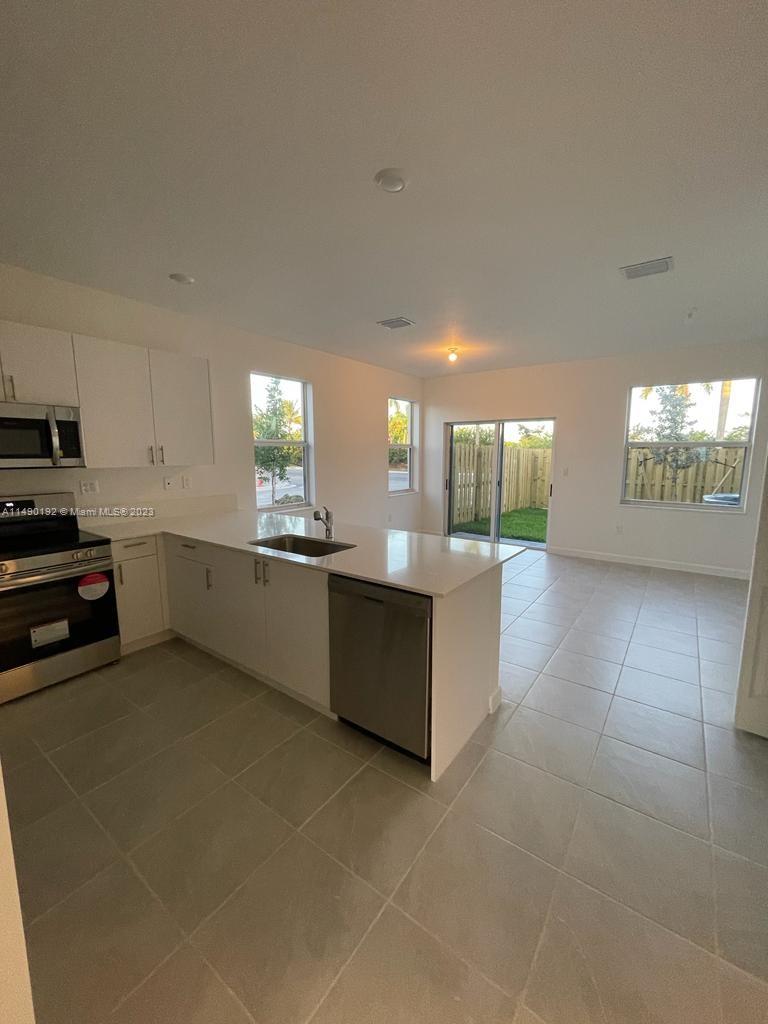 29111 Southwest 162th Court Homestead, FL 33033 - Photo 3 of 15 a large kitchen with a large counter top stainless steel appliances and cabinets