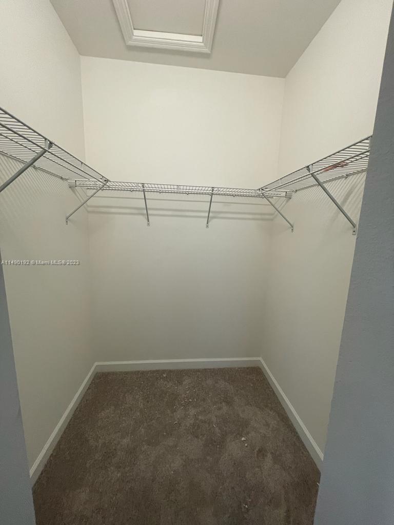 29111 Southwest 162th Court Homestead, FL 33033 - Photo 9 of 15 a view of a room with racks on the wall