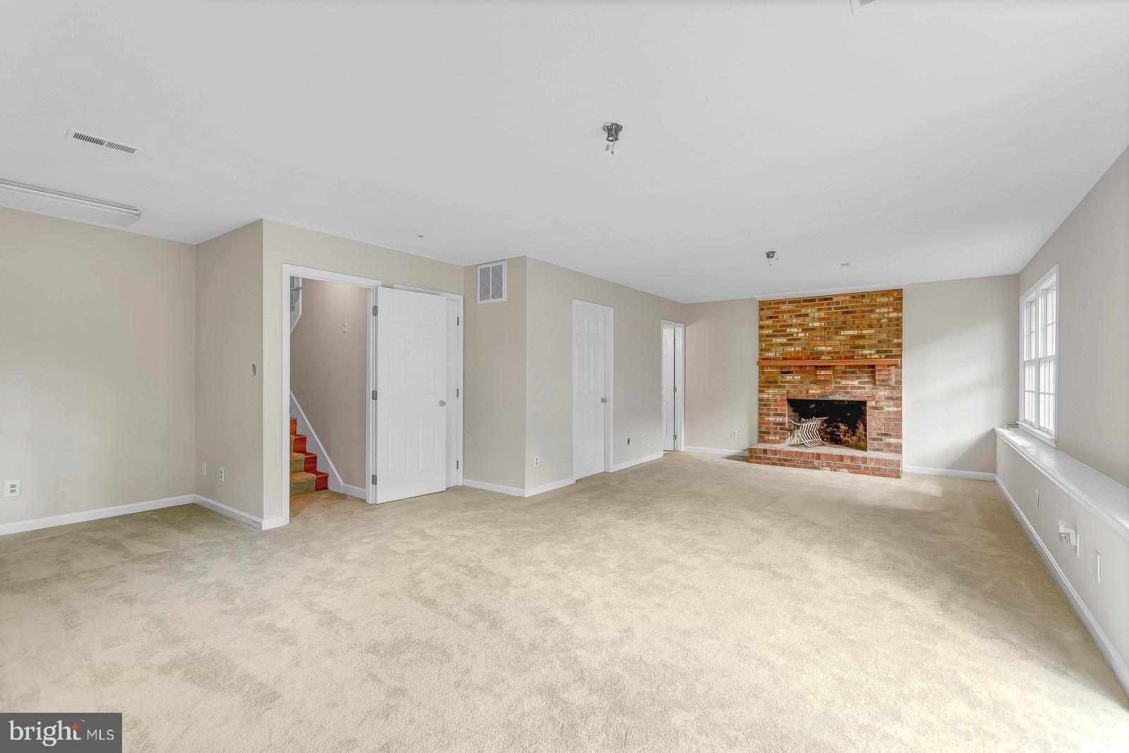 1010 Planters Wharf Road Lusby, MD 20657 - Photo 21 of 26 Fantastic lower level fam room w/ brick fireplace
