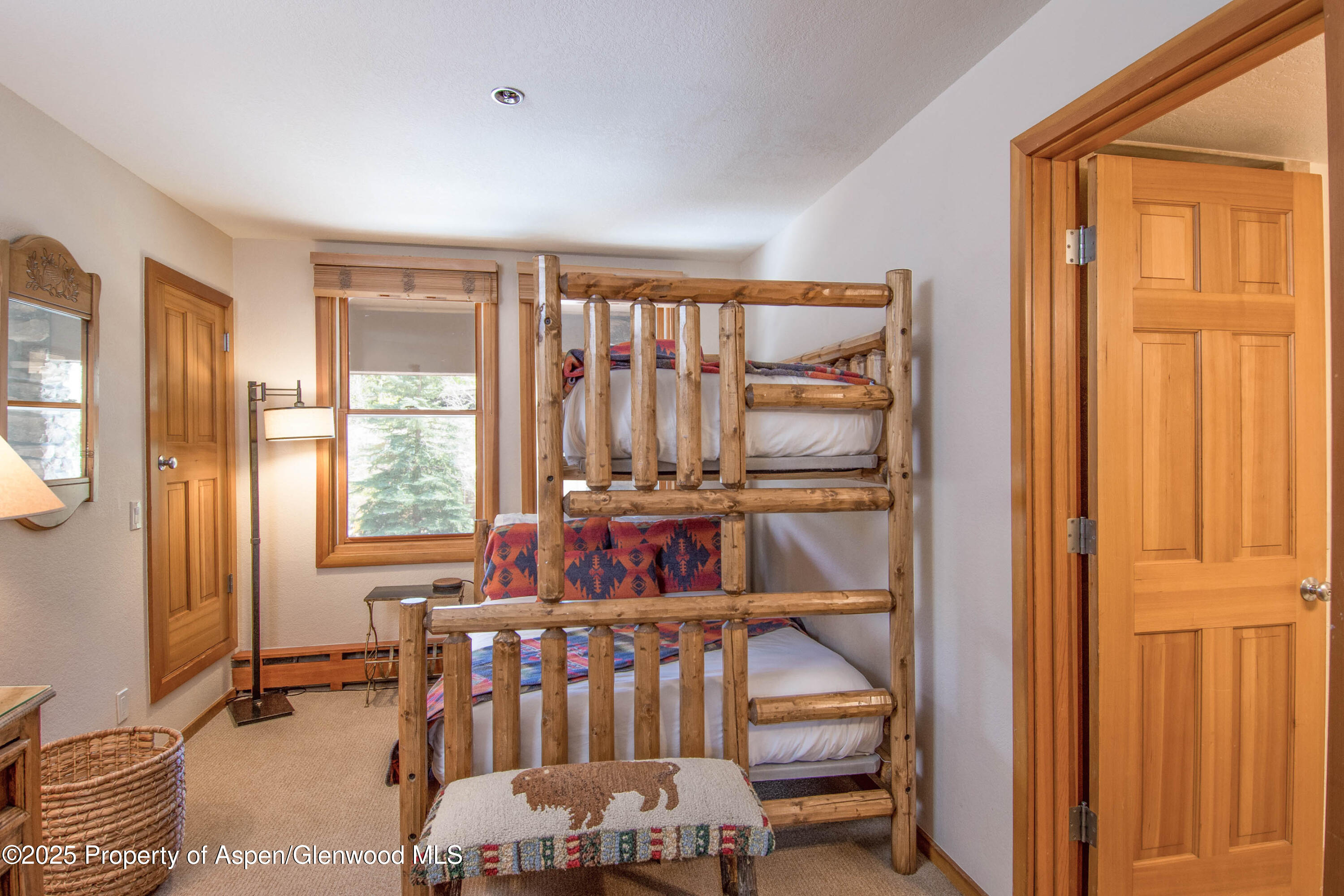 425 Wood Road, Unit 48 Snowmass Village, CO 81615 - Photo 29 of 41 a bedroom with furniture and a window