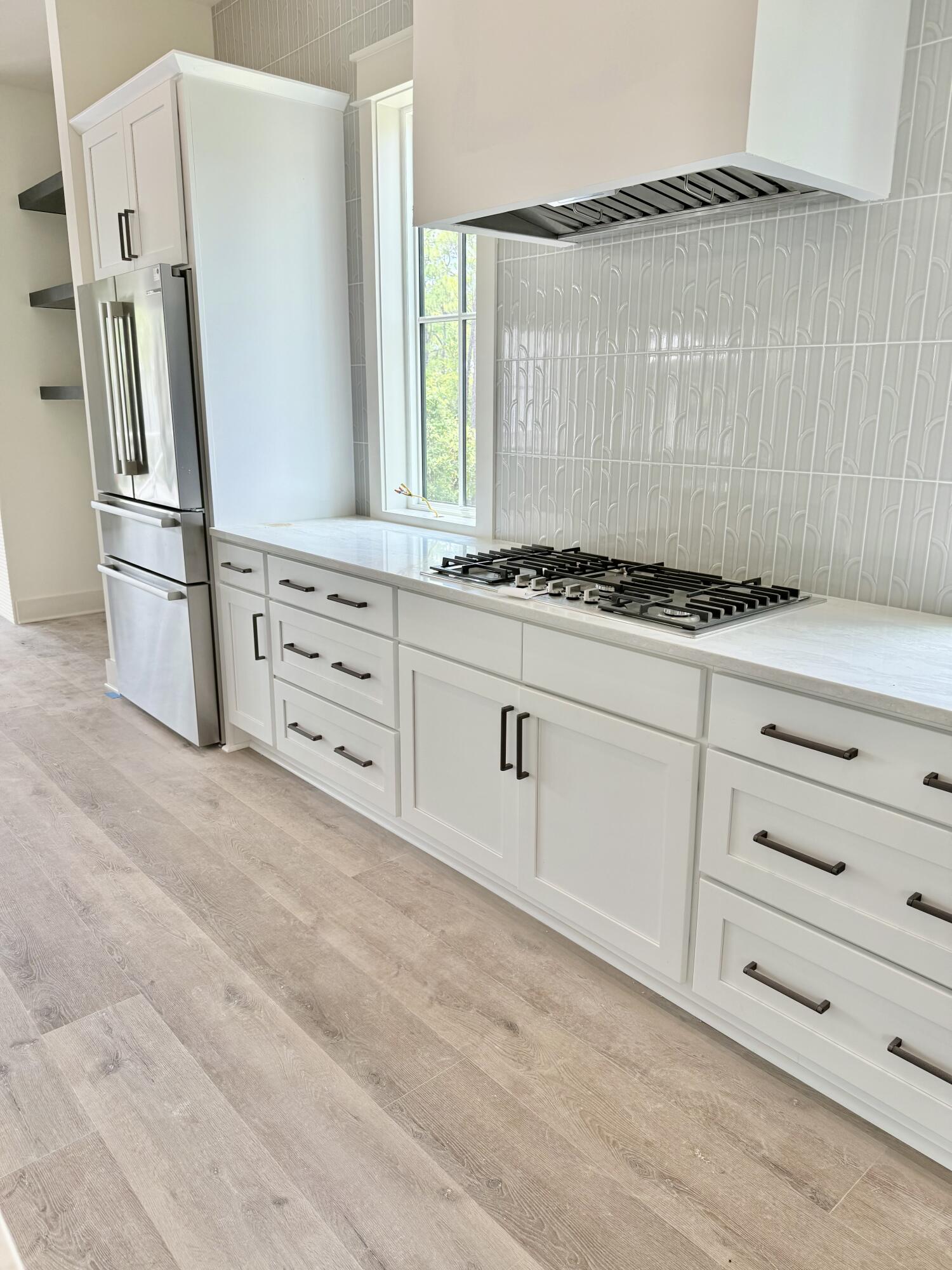 Lot 45 Sweet Gum Inlet Beach Inlet Beach, FL 32461 - Photo 22 of 56 a kitchen with appliances cabinets and a window
