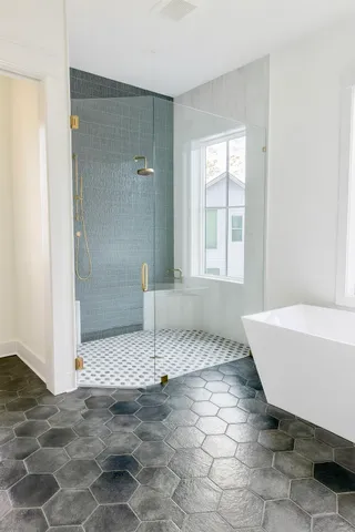 a bathroom with a tub shower and sink
