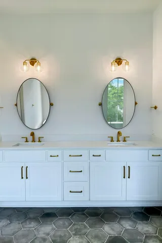 a bathroom with a sink mirror and vanity