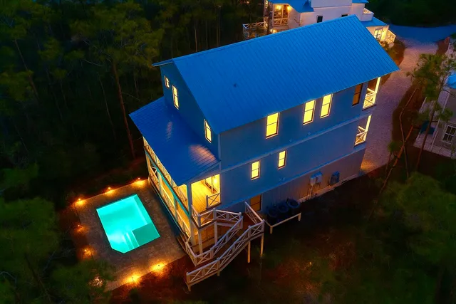 a view of a chairs and table in the backyard
