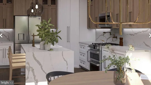 a kitchen with stainless steel appliances a stove refrigerator and microwave