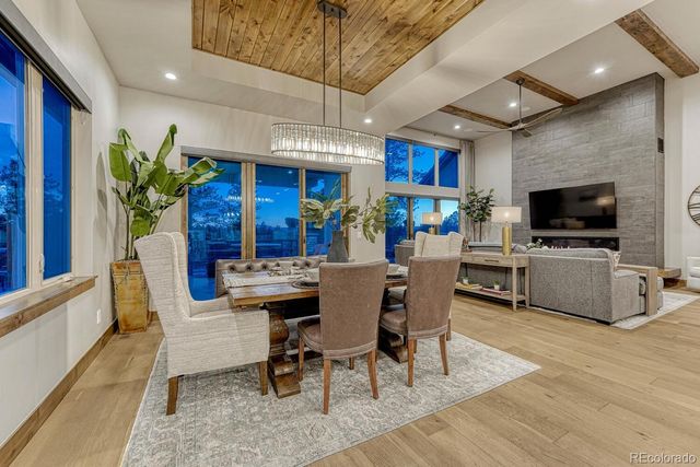 a view of a dining room with furniture a kitchen and chandelier