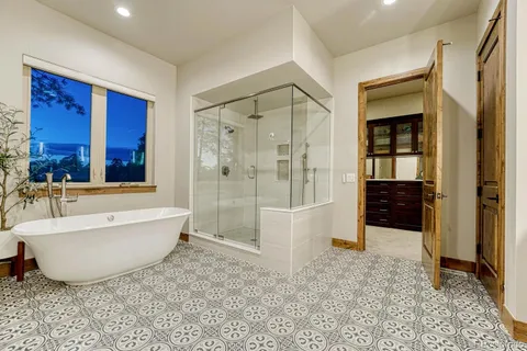 a bathroom with a bathtub and a shower