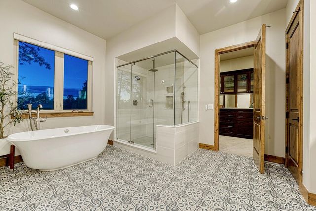 a bathroom with a bathtub and a shower