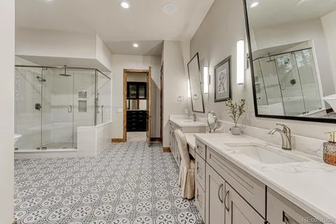a spacious bathroom with a shower sink and mirror