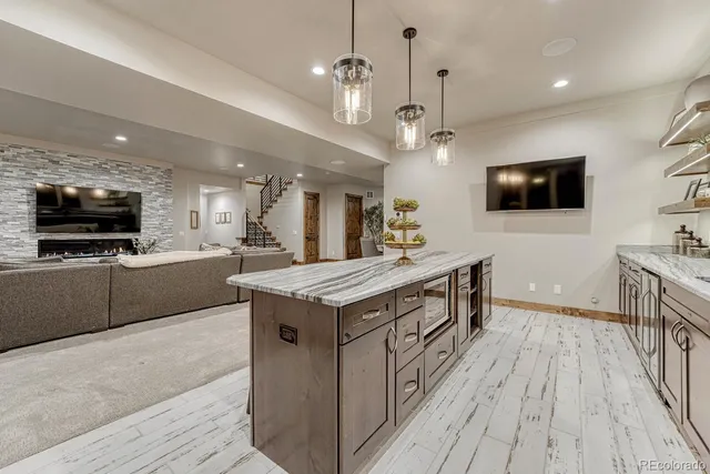 a kitchen with stainless steel appliances granite countertop a stove and a wooden floors
