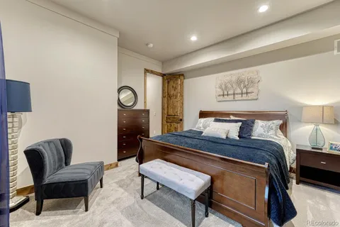 a bed room with a bed and chair