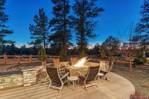 a view of a patio with table and chairs and potted plants