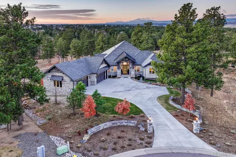 a front view of a house with a yard and a garage