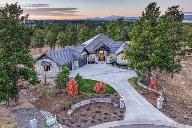 a front view of a house with a yard and a garage