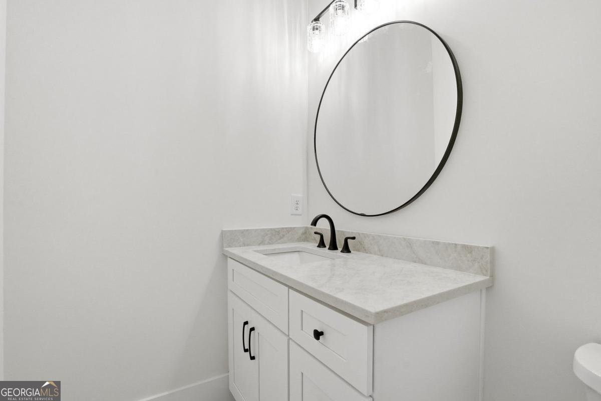 1557 Whitley Road Dacula, GA 30019 - Photo 35 of 46 a bathroom with a sink and a mirror