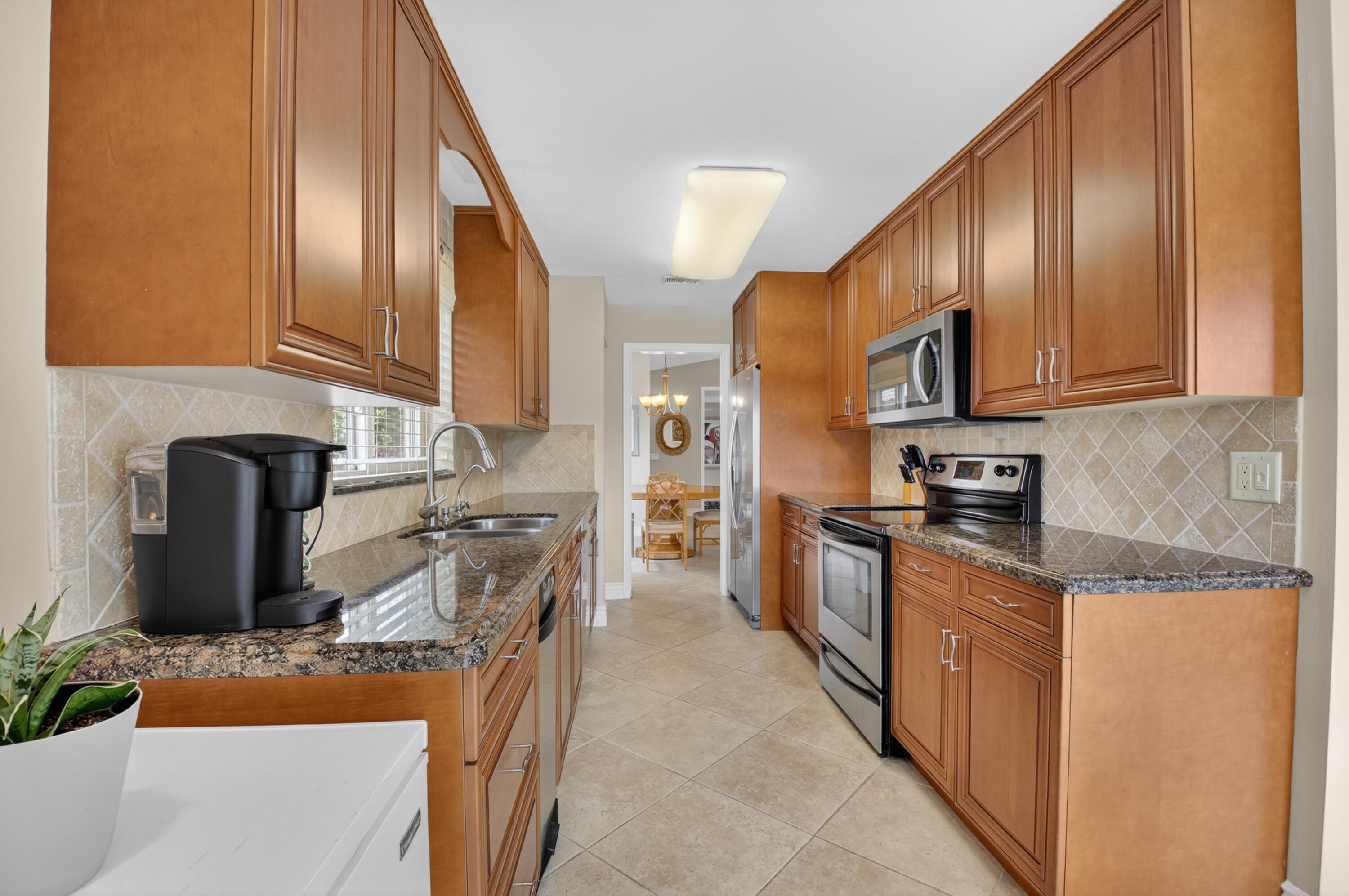 11253 Cloverleaf Circle Boca Raton, FL 33428 - Photo 17 of 79 a kitchen with stainless steel appliances granite countertop a refrigerator a stove top oven a sink and dishwasher