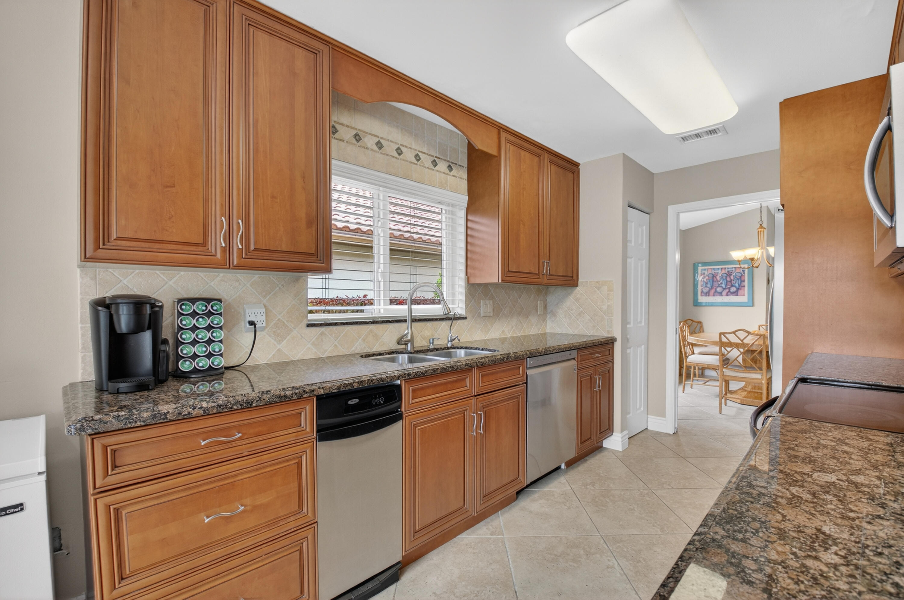 11253 Cloverleaf Circle Boca Raton, FL 33428 - Photo 19 of 79 a kitchen with stainless steel appliances granite countertop a sink stove and cabinets