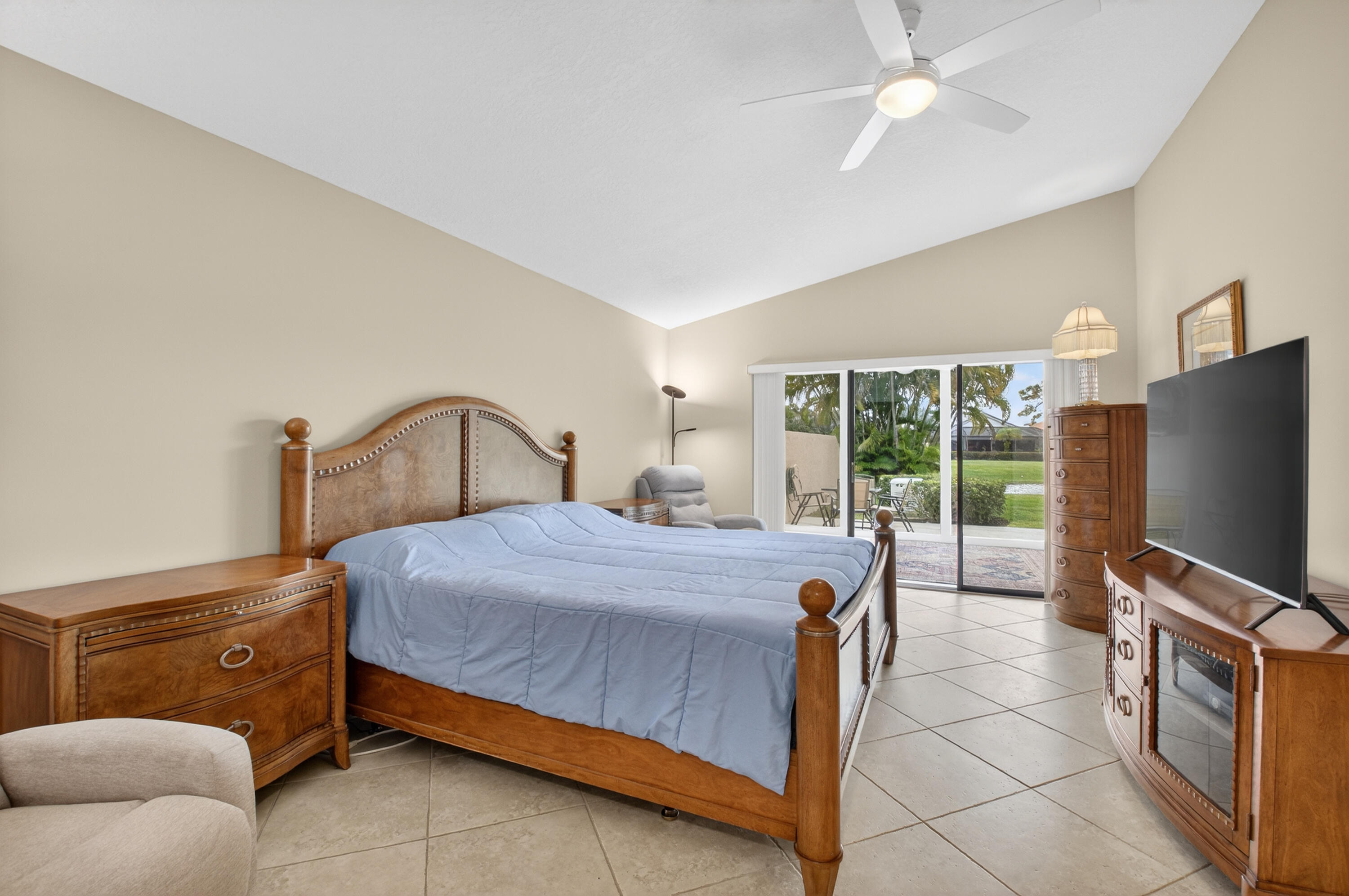 11253 Cloverleaf Circle Boca Raton, FL 33428 - Photo 28 of 79 a bedroom with a bed and a flat tv screen on dresser