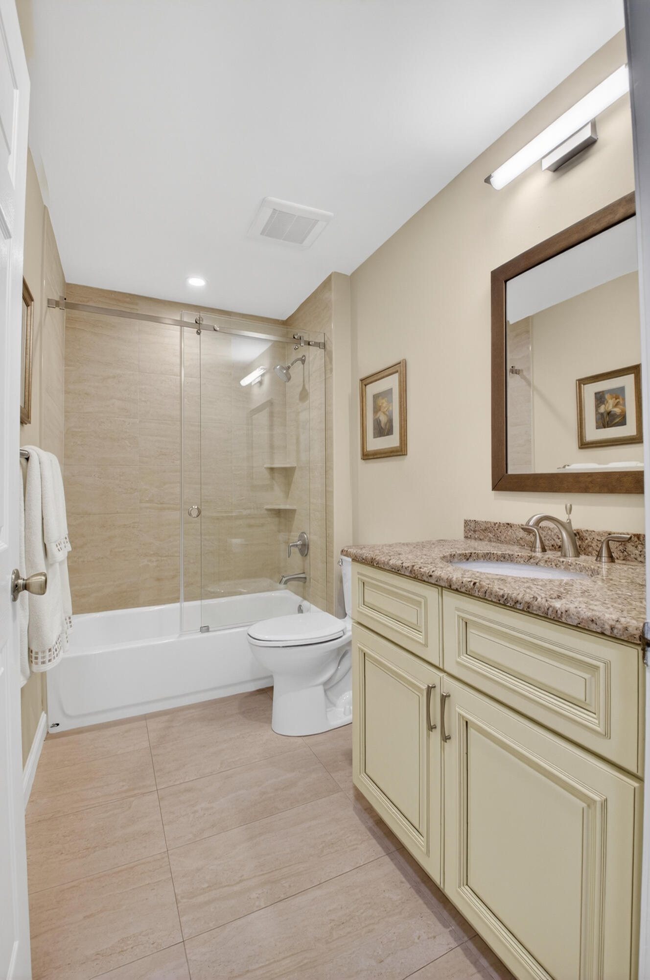 11253 Cloverleaf Circle Boca Raton, FL 33428 - Photo 34 of 79 a bathroom with a granite countertop sink a toilet a mirror and bathtub