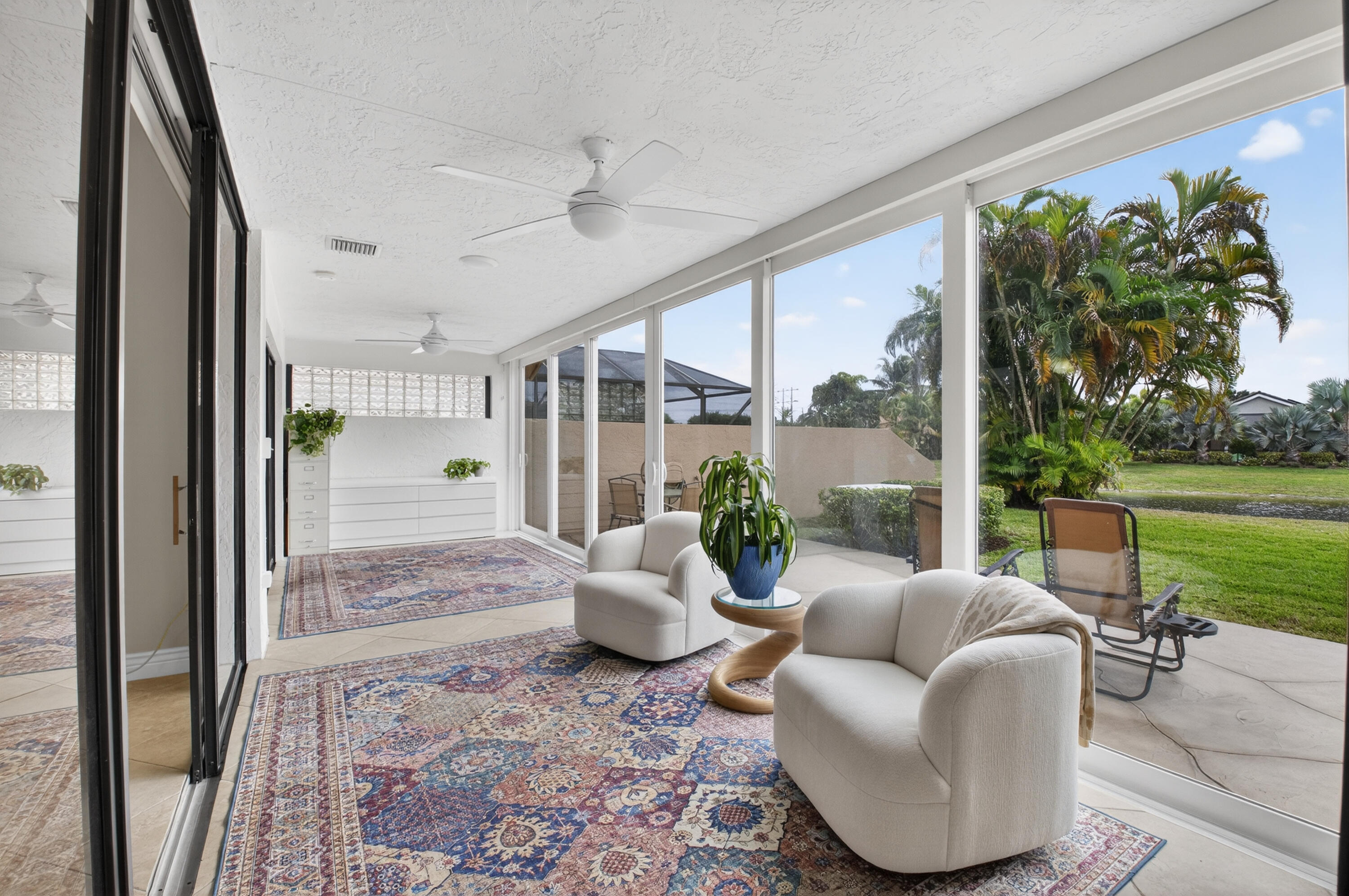 11253 Cloverleaf Circle Boca Raton, FL 33428 - Photo 37 of 79 a living room with furniture and a floor to ceiling window