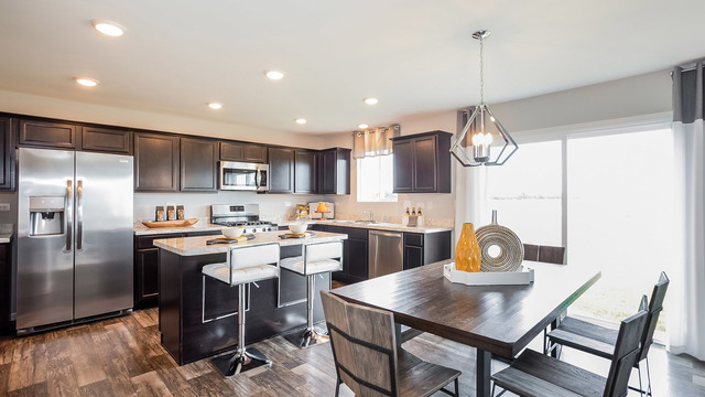 3738 Doherty Lane McHenry, IL 60050 - Photo 6 of 12 a kitchen with a dining table and chairs