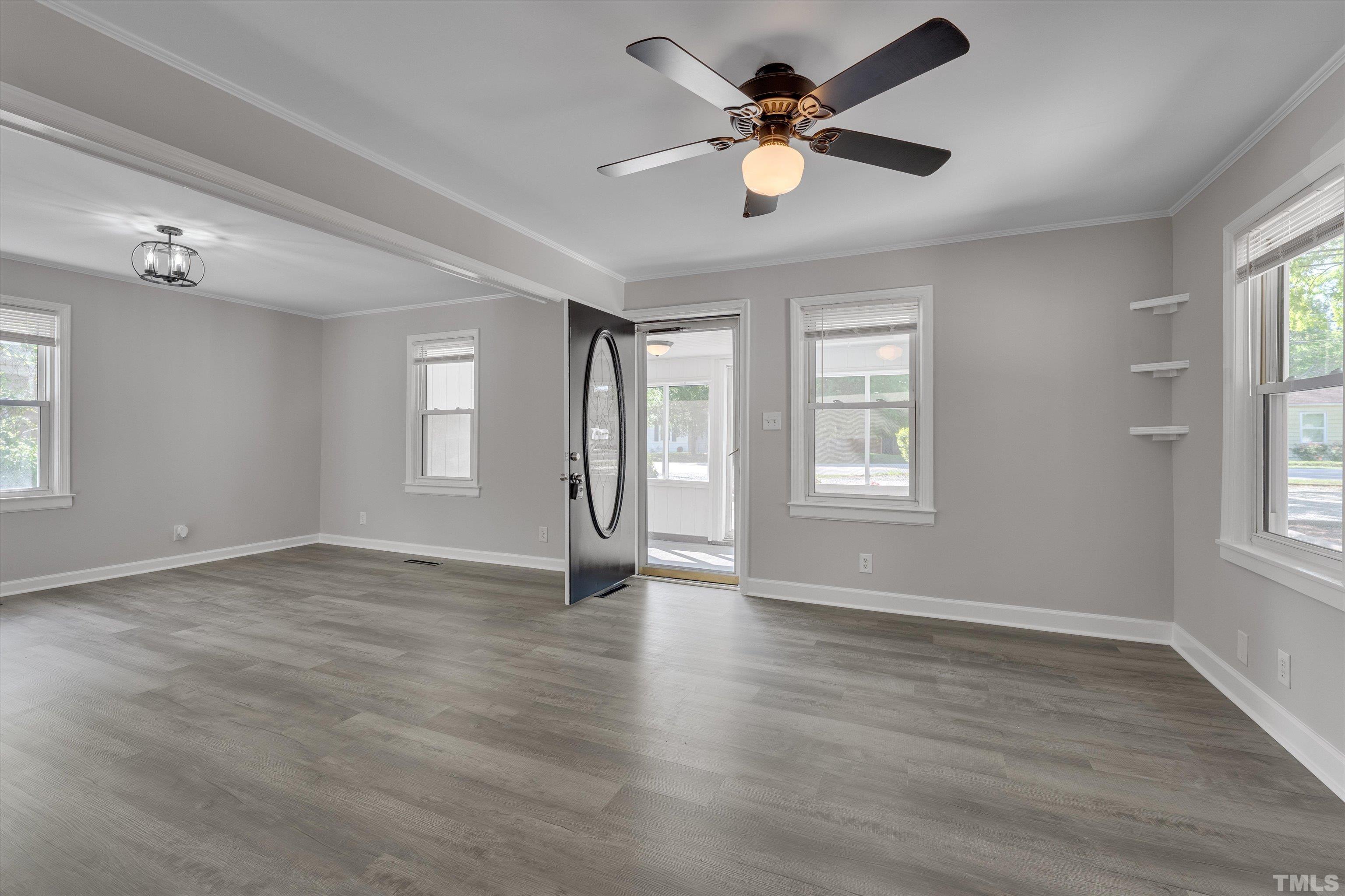 308 South Mineral Springs Road Durham, NC 27703 - Photo 11 of 42 a view of an empty room with a window and wooden floor